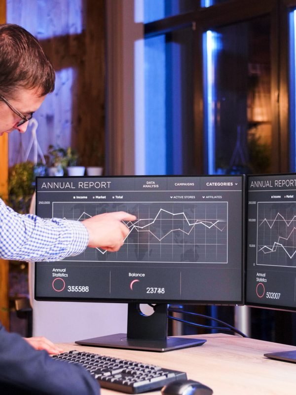 Two colleagues working late at the office. Blue light and night view